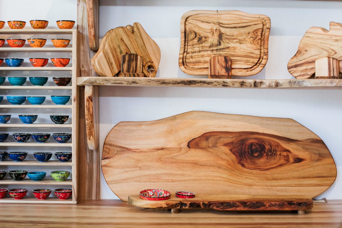 On display is a beautiful selection of camphor laurel wooden serving platters and cutting boards handcrafted by Nature's Boards at the Eumundi Markets Stall 324 on the Sunshine Coast, plus a variety of colourful Turkish bowls, to accompany the food boards