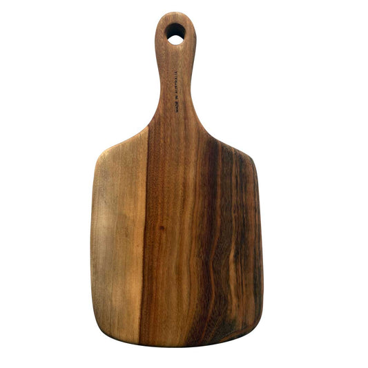 A wood charcuterie paddle or chopping board from Nature's Boards, designed with a handle in camphor laurel timber.