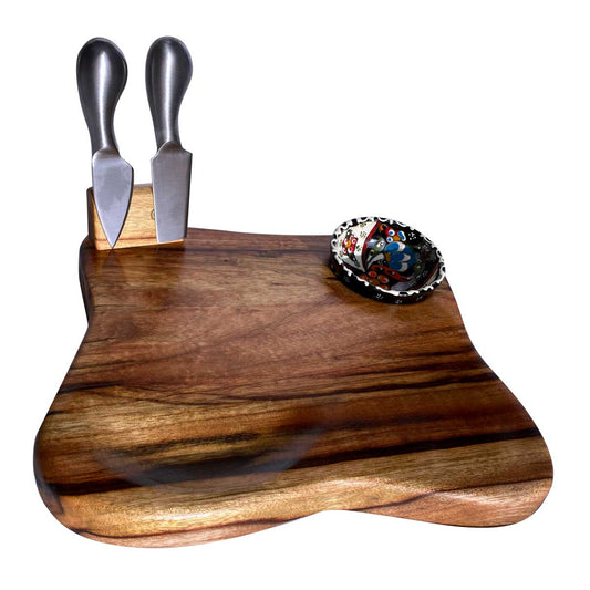 A beautiful medium size camphor laurel wood serving platter, with a small carved indent. Included is a small turkish bowl and a two piece cheese tool set. Waiting to be filled with cheeses and cured meats. Handcrafted by Nature's Boards.