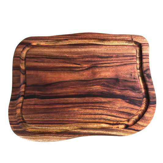 A large freeform carving board with a deep groove or juice rail to catch spills, made with camphor laurel timber with gorgeous colours and grains designed by Nature's Boards.