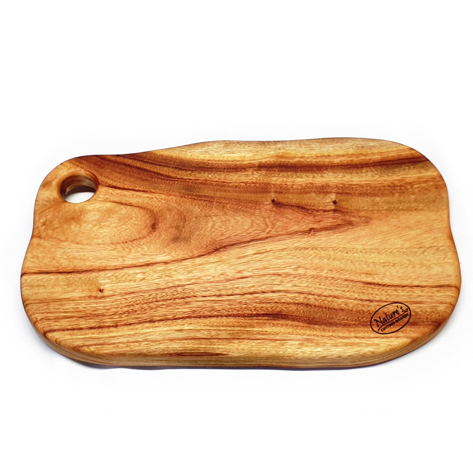 A large, freeform wooden cutting and chopping board from Nature's Boards showing the beautiful camphor laurel timber grains and a variety of colours and tones in the wood.